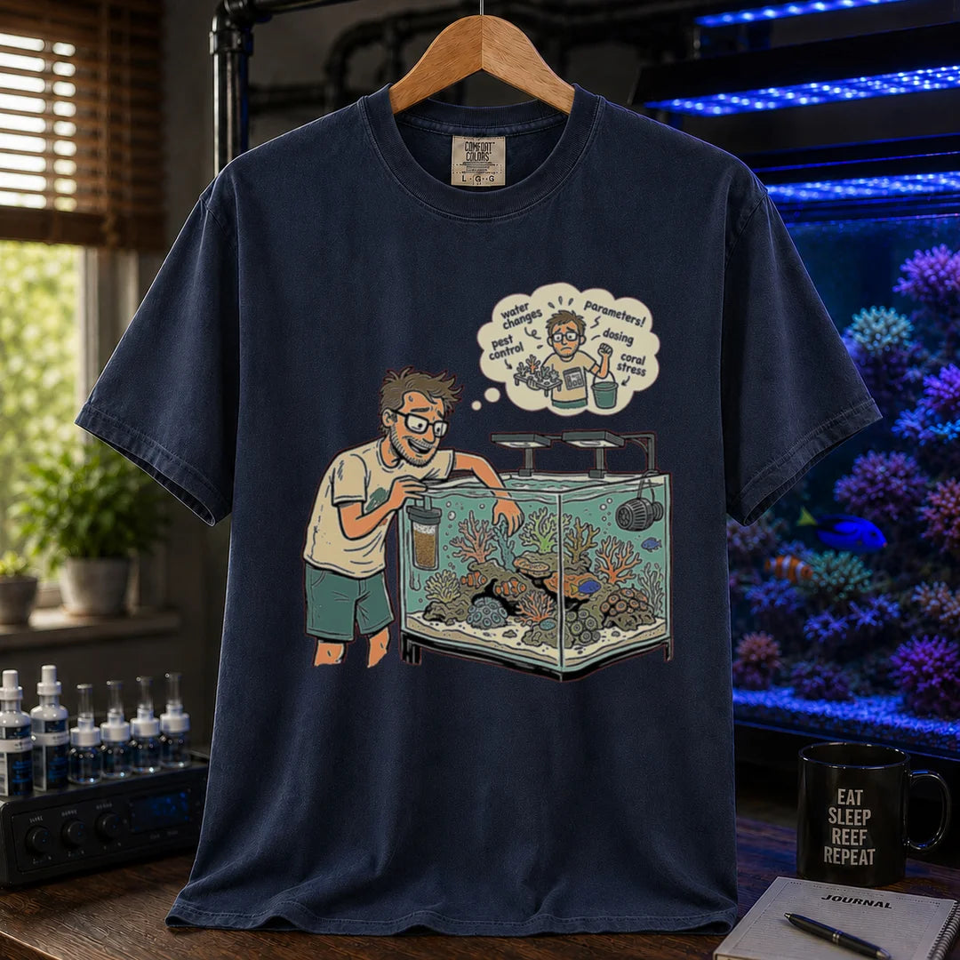 Saltwater aquarium graphic t-shirt featuring an aquarist maintaining a tank with a thought bubble of reef chores, navy crew neck tee