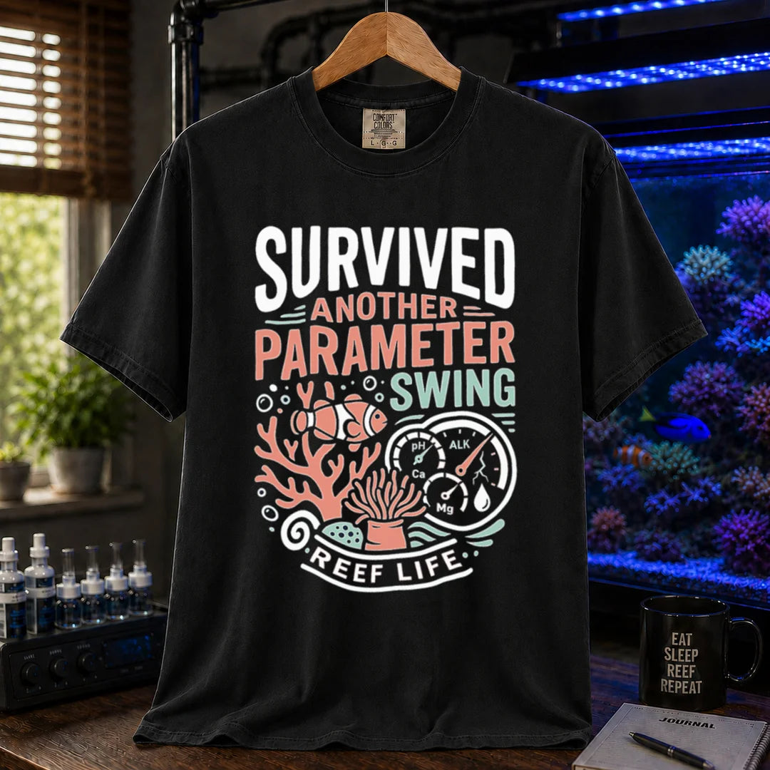 Saltwater aquarium graphic t-shirt featuring a clownfish, coral, parameter gauges, and text: SURVIVED ANOTHER PARAMETER SWING REEF LIFE, black crew neck tee
