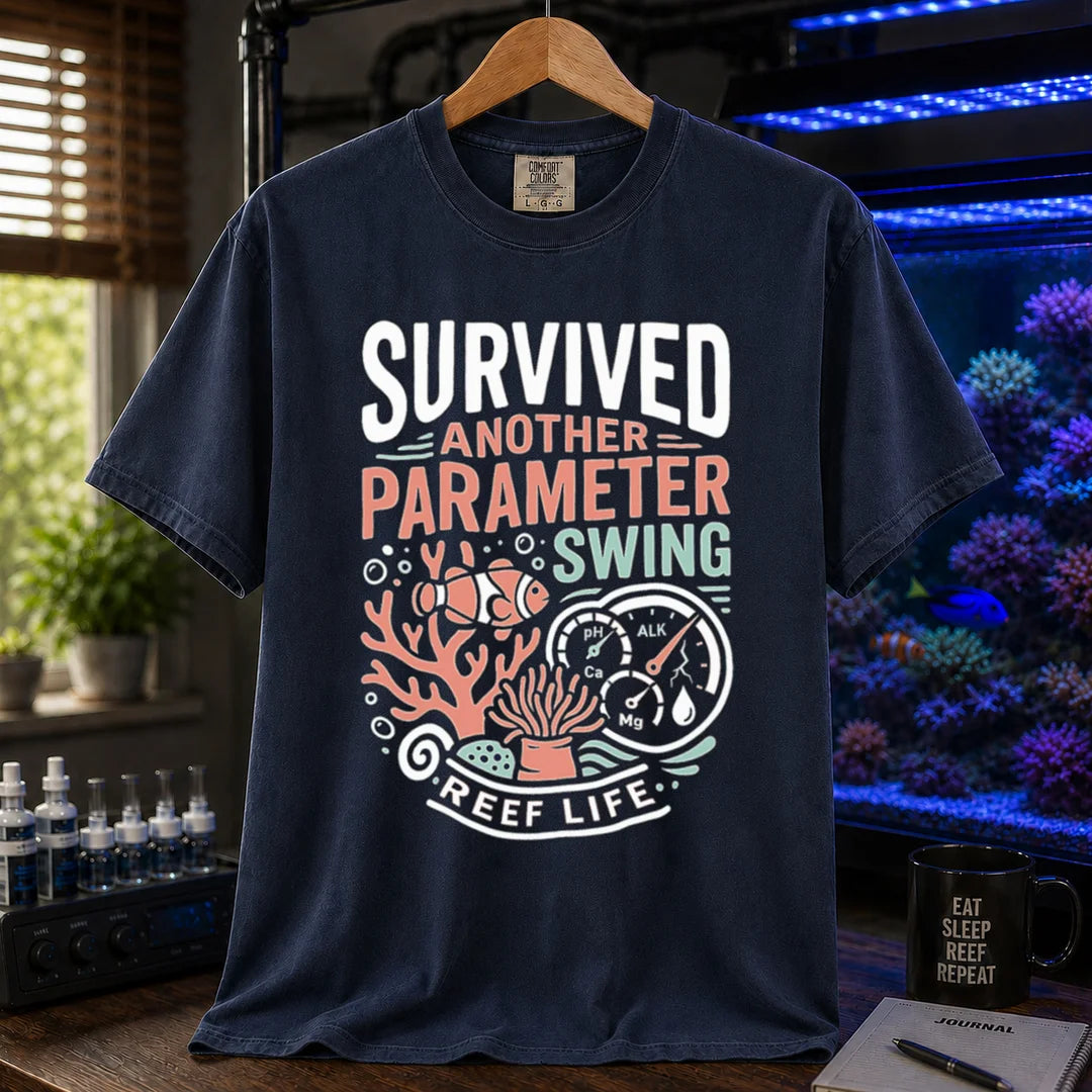 Saltwater aquarium graphic t-shirt featuring a clownfish, coral, parameter gauges, and text: SURVIVED ANOTHER PARAMETER SWING REEF LIFE, navy crew neck tee