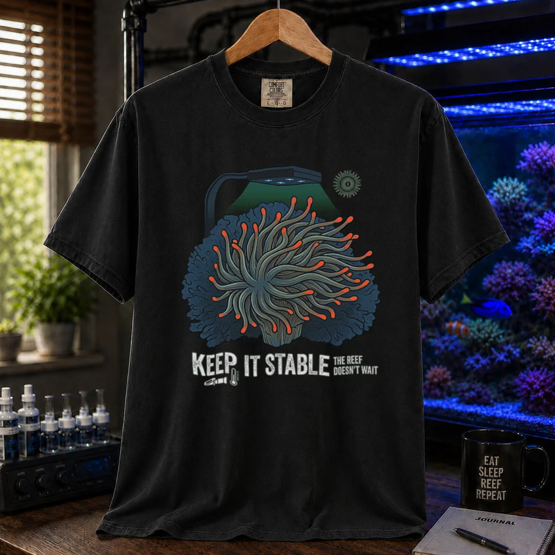 Saltwater aquarium graphic t-shirt featuring an anemone illustration under a reef light and text: KEEP IT STABLE THE REEF DOESN'T WAIT, black crew neck tee