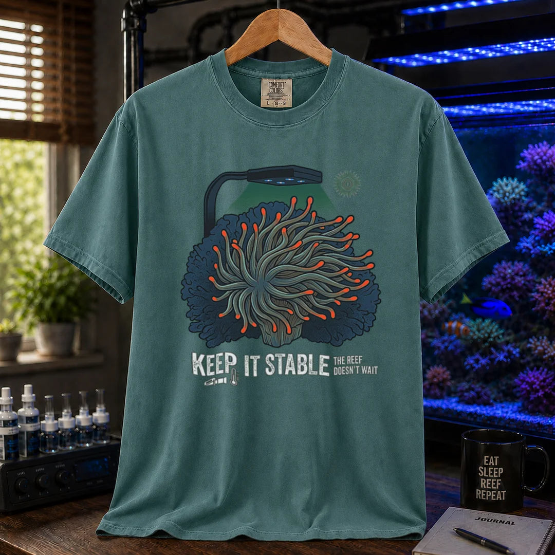 Saltwater aquarium graphic t-shirt featuring an anemone illustration under a reef light and text: KEEP IT STABLE THE REEF DOESN'T WAIT, green crew neck tee