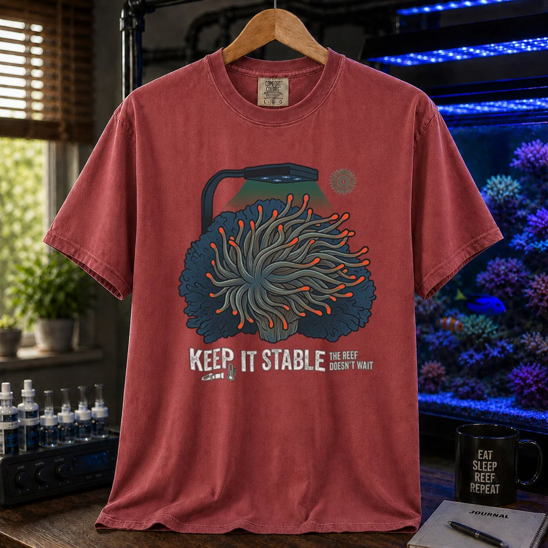 Saltwater aquarium graphic t-shirt featuring an anemone illustration under a reef light and text: KEEP IT STABLE THE REEF DOESN'T WAIT, maroon, red crew neck tee