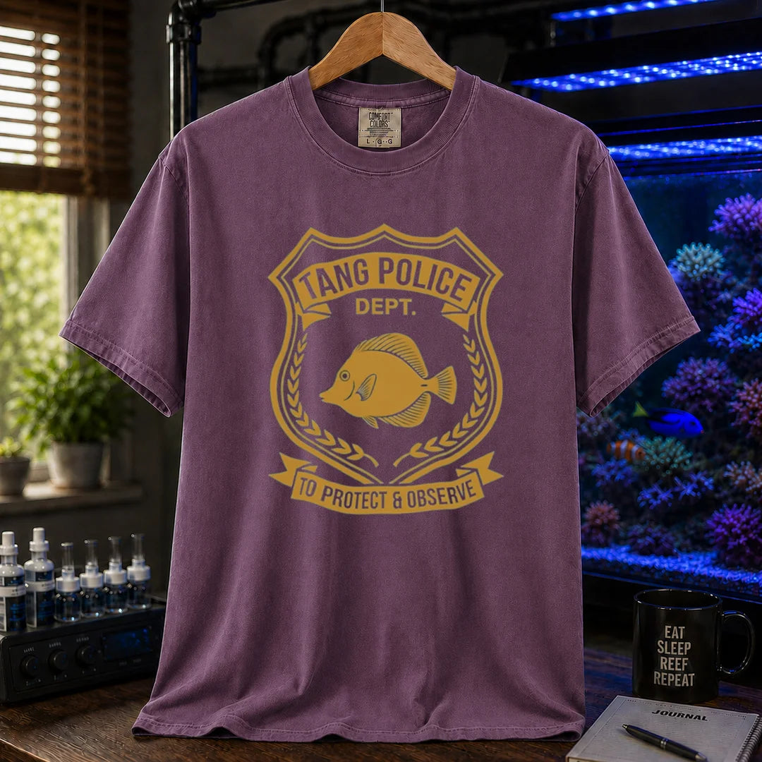 Saltwater aquarium graphic t-shirt featuring a gold police badge with a tang fish and text: TANG POLICE DEPT. TO PROTECT & OBSERVE, purple crew neck tee