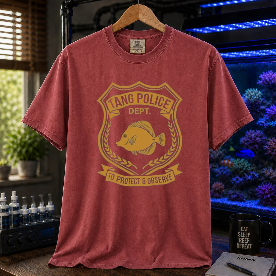 Saltwater aquarium graphic t-shirt featuring a gold police badge with a tang fish and text: TANG POLICE DEPT. TO PROTECT & OBSERVE, maroon, red crew neck tee