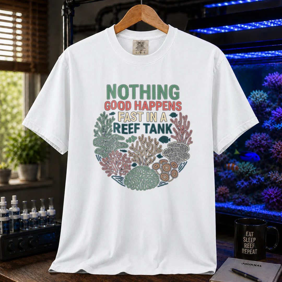 Saltwater aquarium graphic t-shirt featuring a circular coral wreath illustration and colorful text: NOTHING GOOD HAPPENS FAST IN A REEF TANK, white crew neck tee