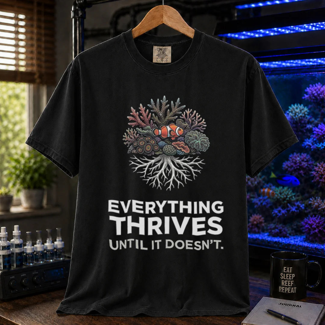 Saltwater aquarium graphic t-shirt featuring a coral reef cluster with a clownfish and text: EVERYTHING THRIVES UNTIL IT DOESN'T., black crew neck tee