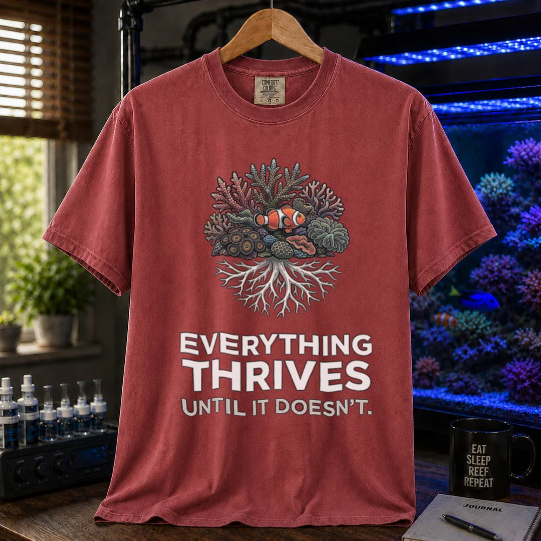 Saltwater aquarium graphic t-shirt featuring a coral reef cluster with a clownfish and text: EVERYTHING THRIVES UNTIL IT DOESN'T., maroon, red crew neck tee