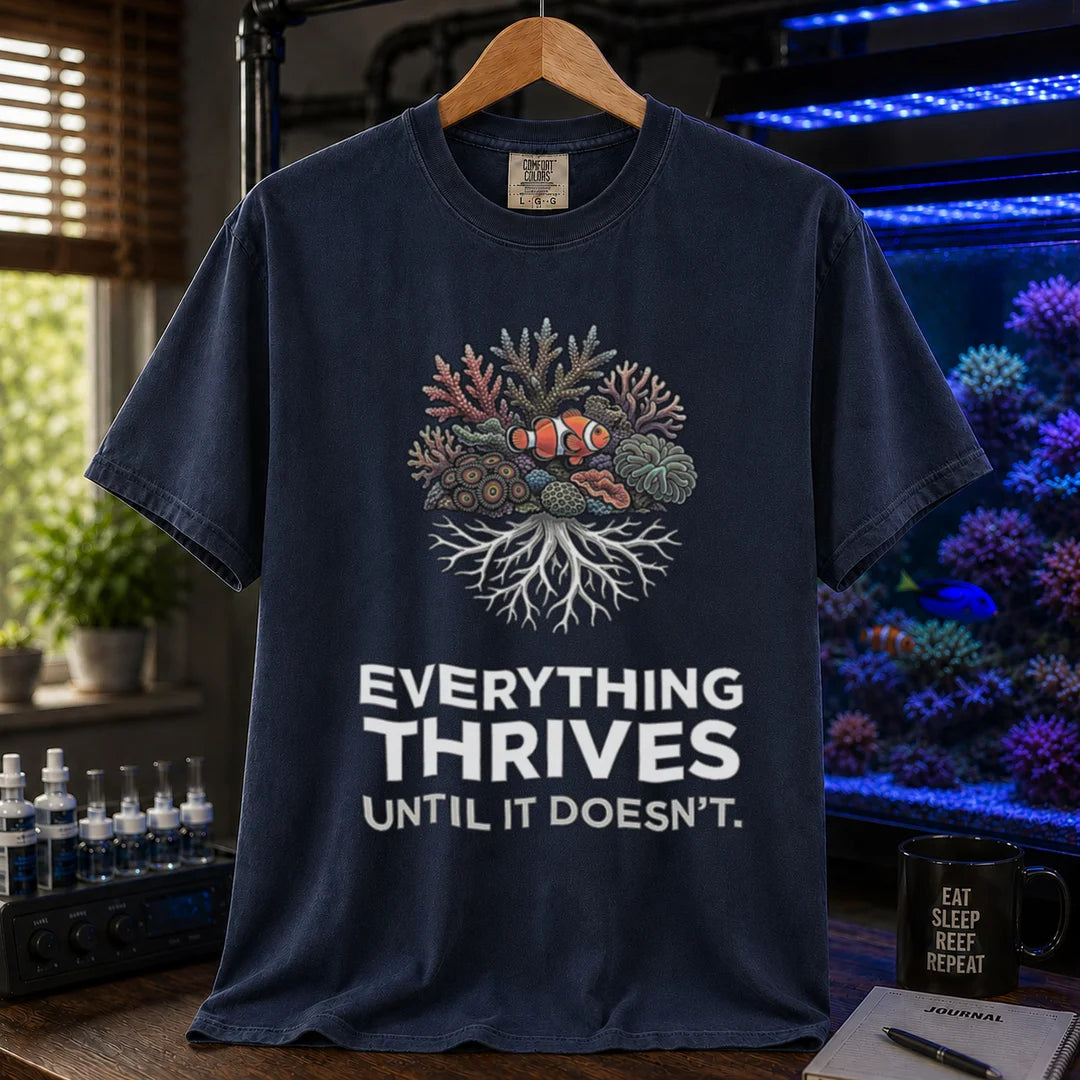 Saltwater aquarium graphic t-shirt featuring a coral reef cluster with a clownfish and text: EVERYTHING THRIVES UNTIL IT DOESN'T., navy crew neck tee