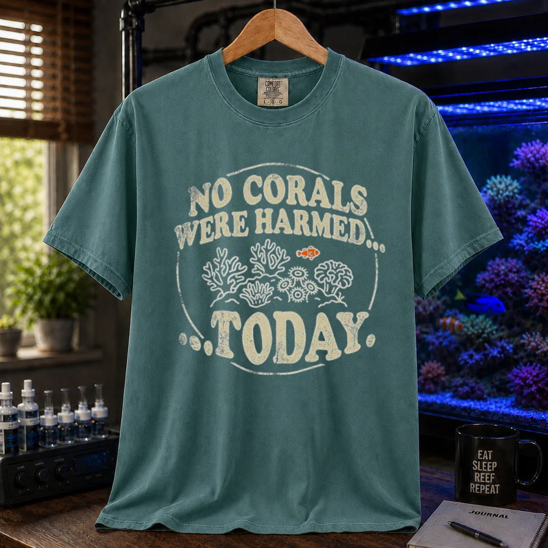 Saltwater aquarium graphic t-shirt featuring a circular badge with corals and text: NO CORALS WERE HARMED... TODAY., green crew neck tee