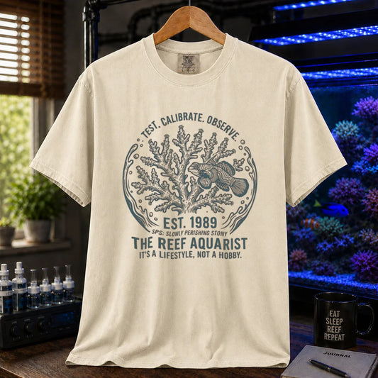 Saltwater aquarium graphic t-shirt featuring a circular coral and fish badge with text: TEST. CALIBRATE. OBSERVE. EST. 1989 THE REEF AQUARIST IT'S A LIFESTYLE, NOT A HOBBY., cream, beige, ivory crew neck tee