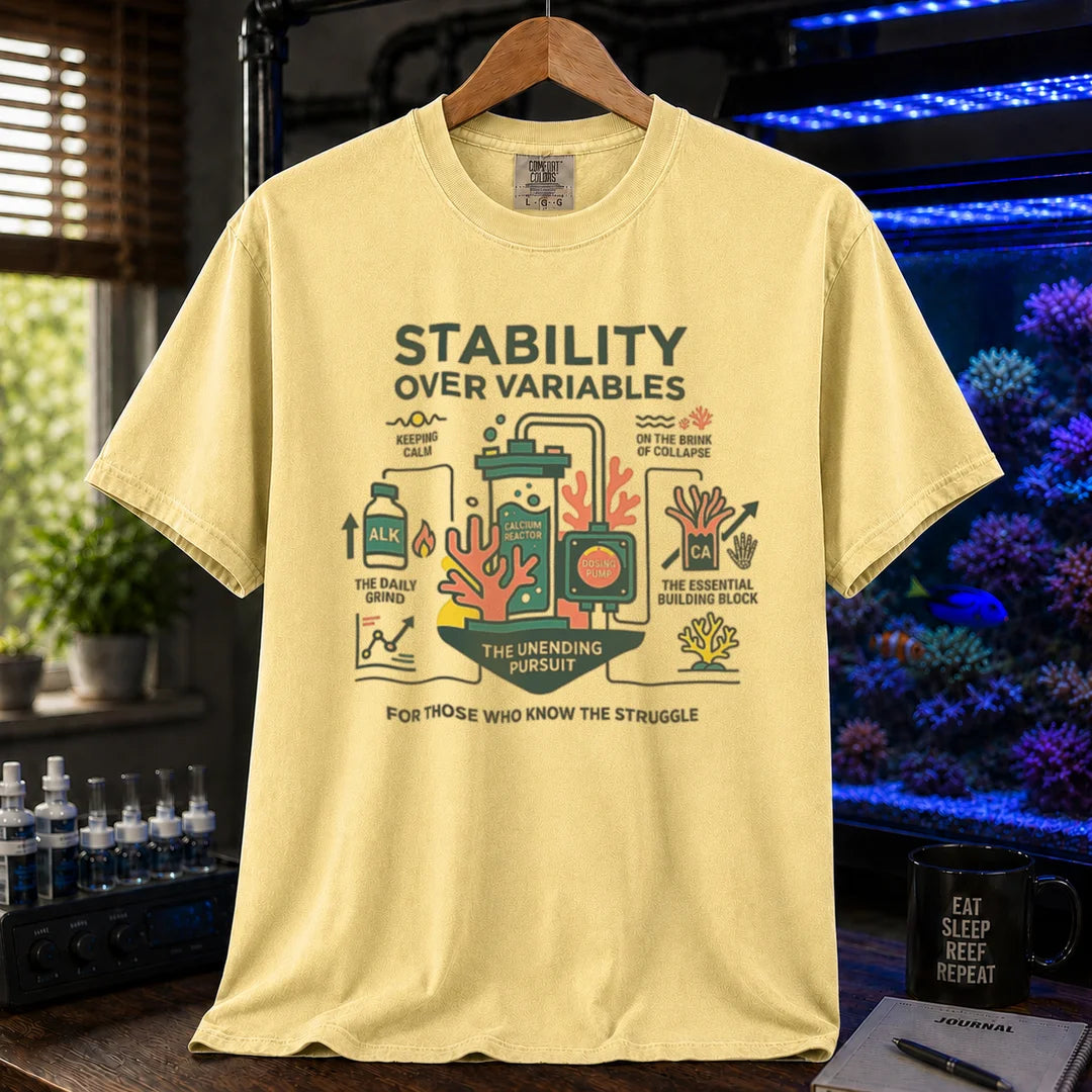 Saltwater aquarium graphic t-shirt featuring a detailed technical diagram with coral and text: STABILITY OVER VARIABLES FOR THOSE WHO KNOW THE STRUGGLE, yellow crew neck tee