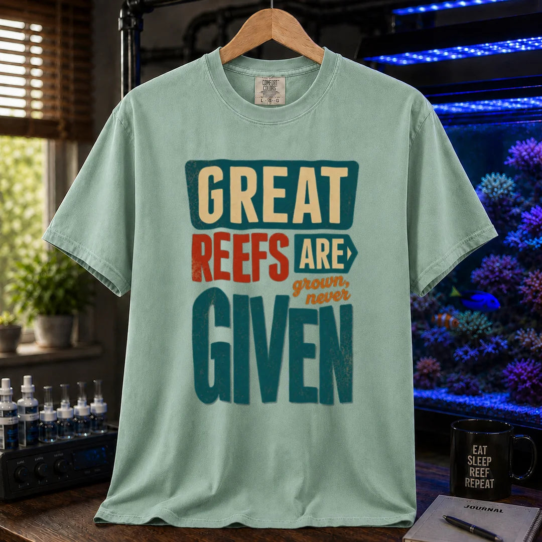 Saltwater aquarium graphic t-shirt featuring bold block text: GREAT REEFS ARE GROWN, NEVER GIVEN, green crew neck tee