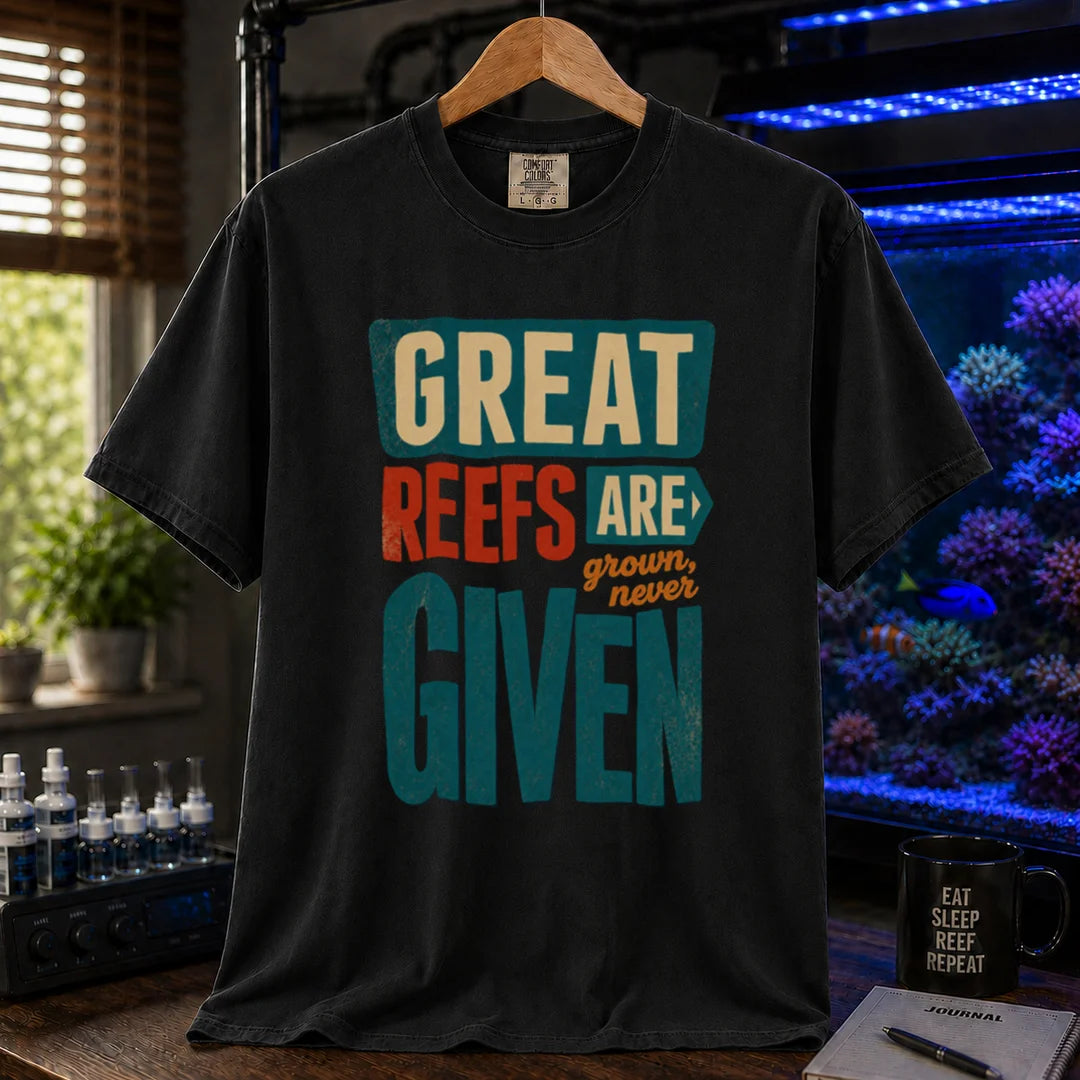 Saltwater aquarium graphic t-shirt featuring bold block text: GREAT REEFS ARE GROWN, NEVER GIVEN, black crew neck tee
