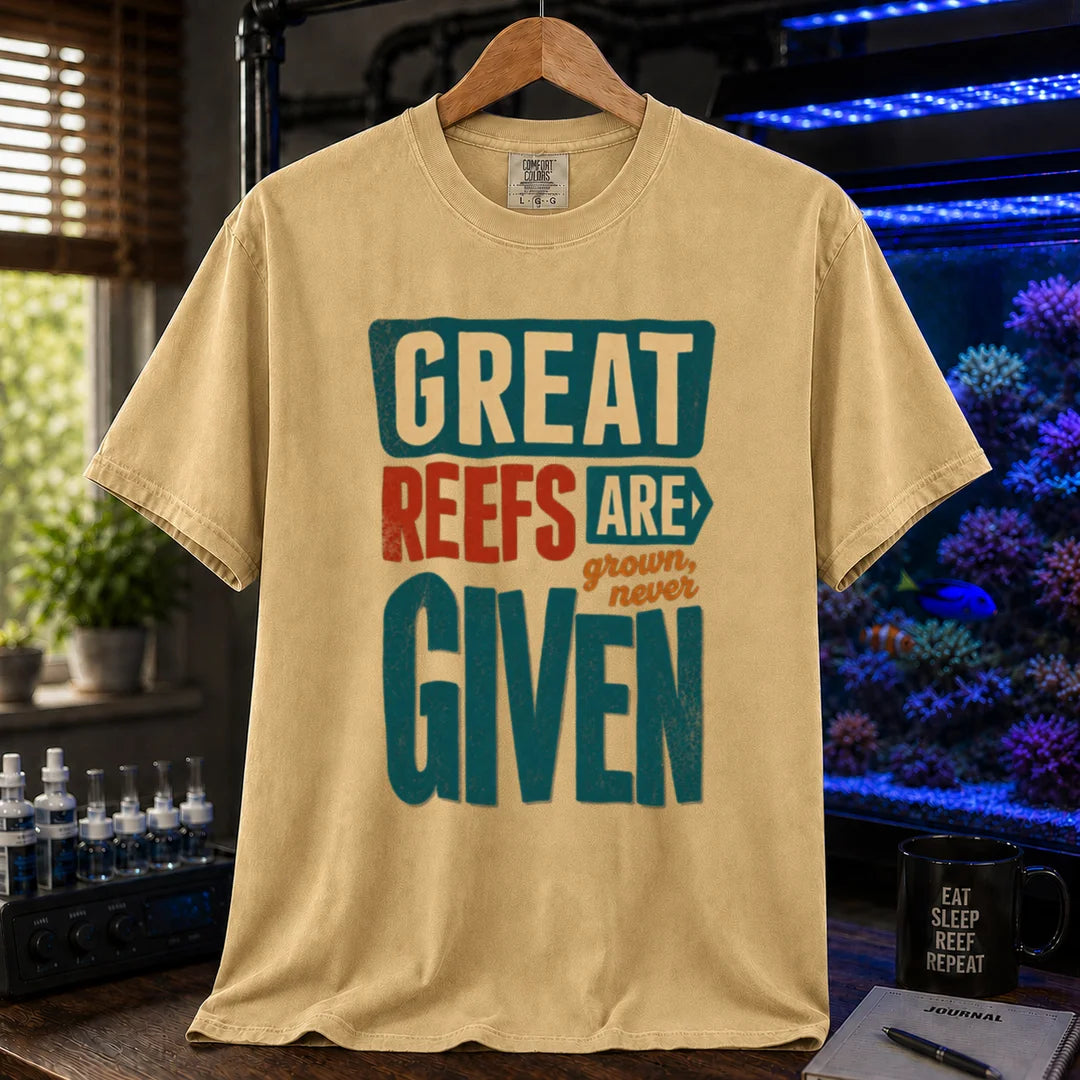 Saltwater aquarium graphic t-shirt featuring bold block text: GREAT REEFS ARE GROWN, NEVER GIVEN, mustard crew neck tee