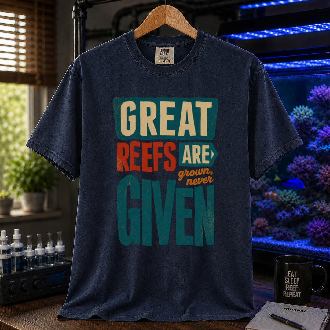 Saltwater aquarium graphic t-shirt featuring bold block text: GREAT REEFS ARE GROWN, NEVER GIVEN, navy crew neck tee