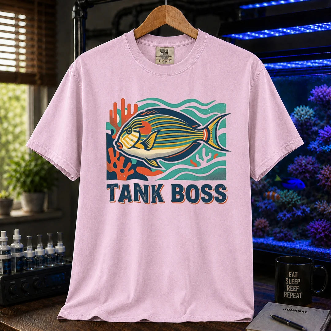 Saltwater aquarium graphic t-shirt featuring a retro illustration of a tang fish with coral and text reading TANK BOSS, pink crew neck tee