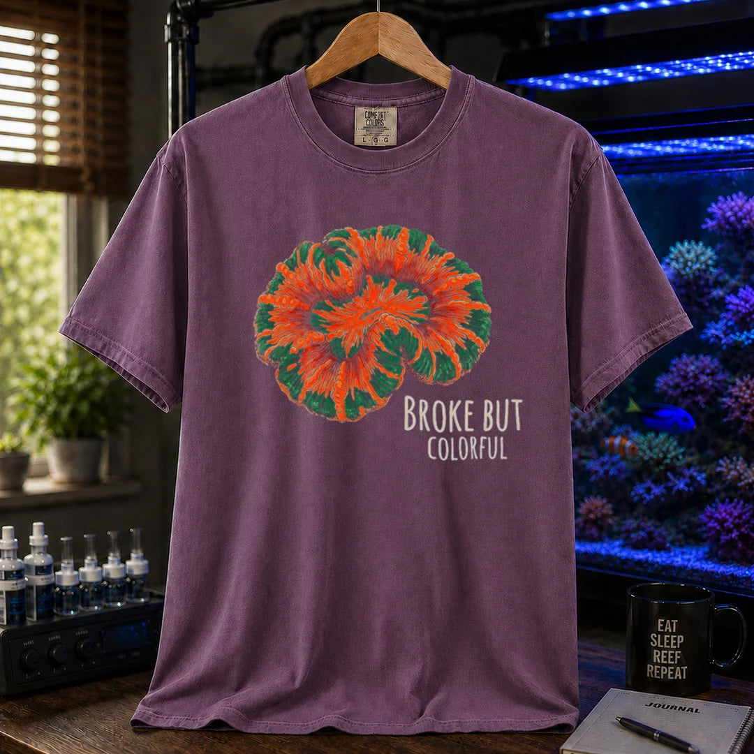 Saltwater aquarium graphic t-shirt featuring an illustration of a brightly colored Scolymia coral and text reading Broke But Colorful, purple crew neck tee