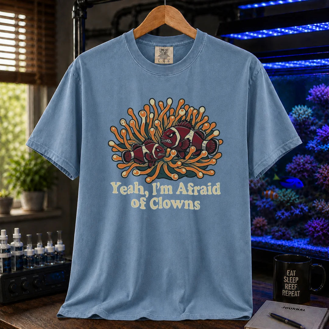 Saltwater aquarium graphic t-shirt featuring an illustration of angry clownfish in an anemone with text reading Yeah, I'm Afraid of Clowns, blue crew neck tee