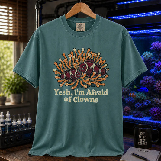 Saltwater aquarium graphic t-shirt featuring an illustration of angry clownfish in an anemone with text reading Yeah, I'm Afraid of Clowns, green crew neck tee