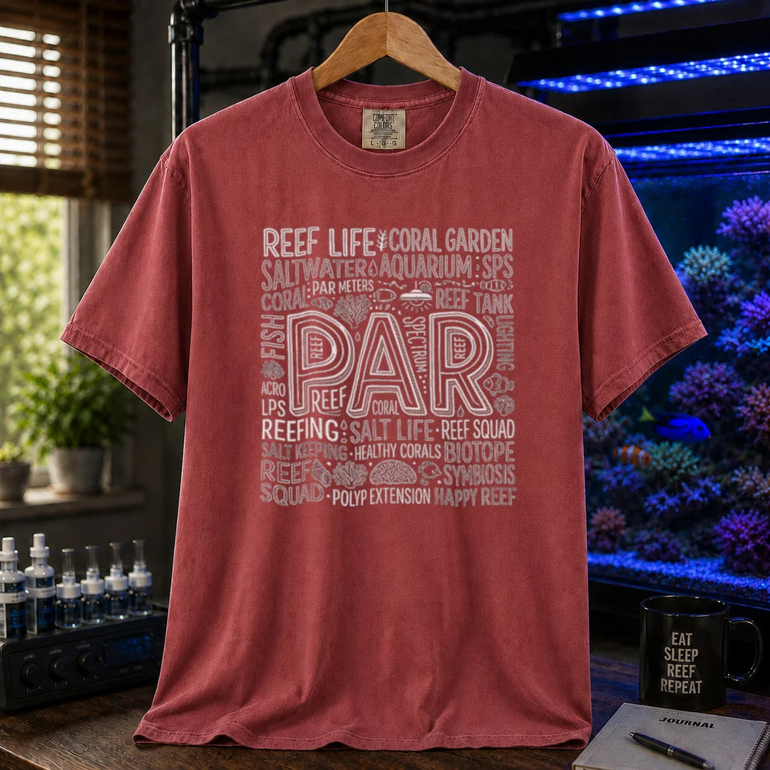 Saltwater aquarium graphic t-shirt featuring a typography collage centered around the word PAR with reef terminology on a maroon, red crew neck tee