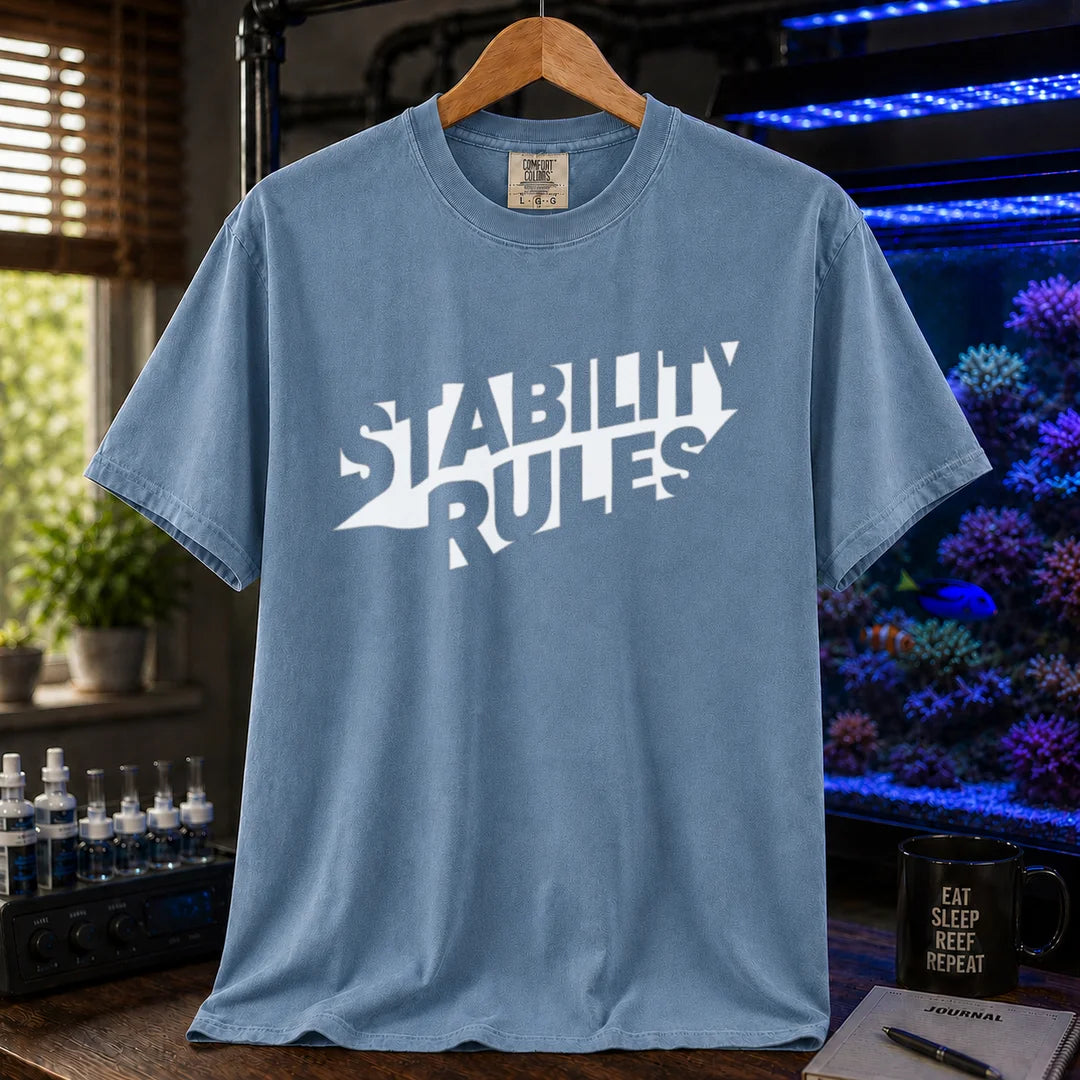 Saltwater aquarium graphic t-shirt featuring bold slanted block text reading STABILITY RULES, blue crew neck tee
