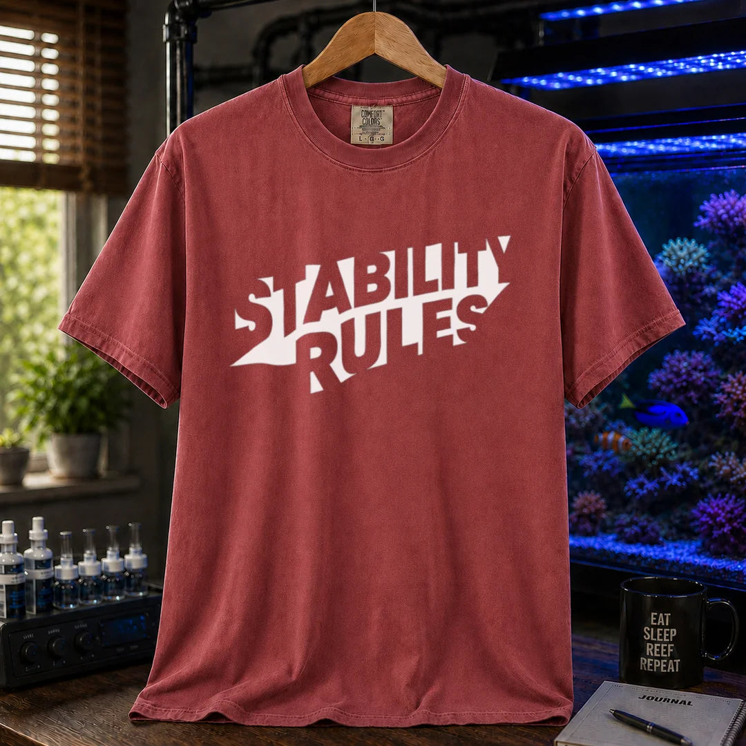 Saltwater aquarium graphic t-shirt featuring bold slanted block text reading STABILITY RULES, maroon, red crew neck tee