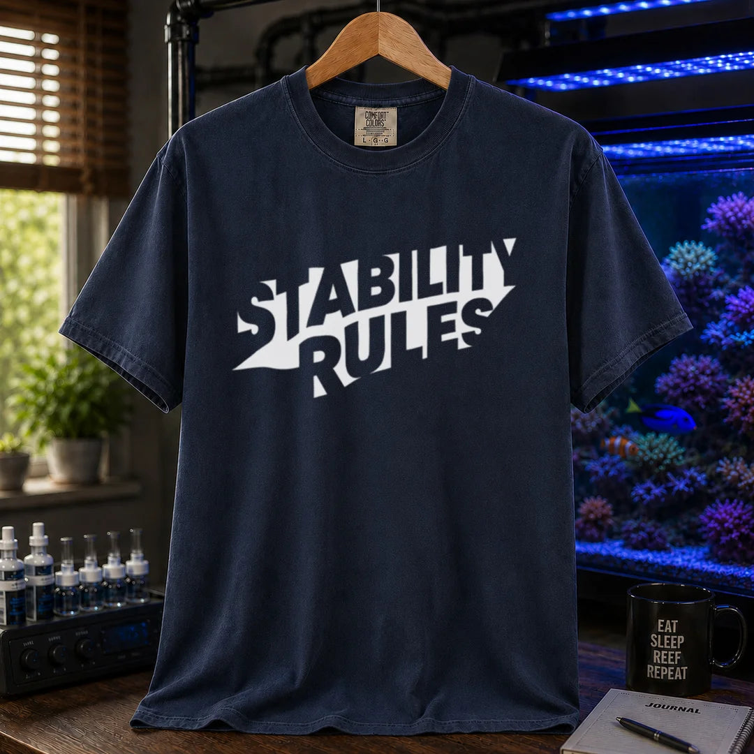 Saltwater aquarium graphic t-shirt featuring bold slanted block text reading STABILITY RULES, navy crew neck tee