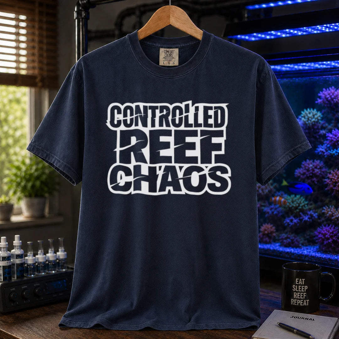 Saltwater aquarium graphic t-shirt featuring bold distressed block text reading CONTROLLED REEF CHAOS, navy crew neck tee