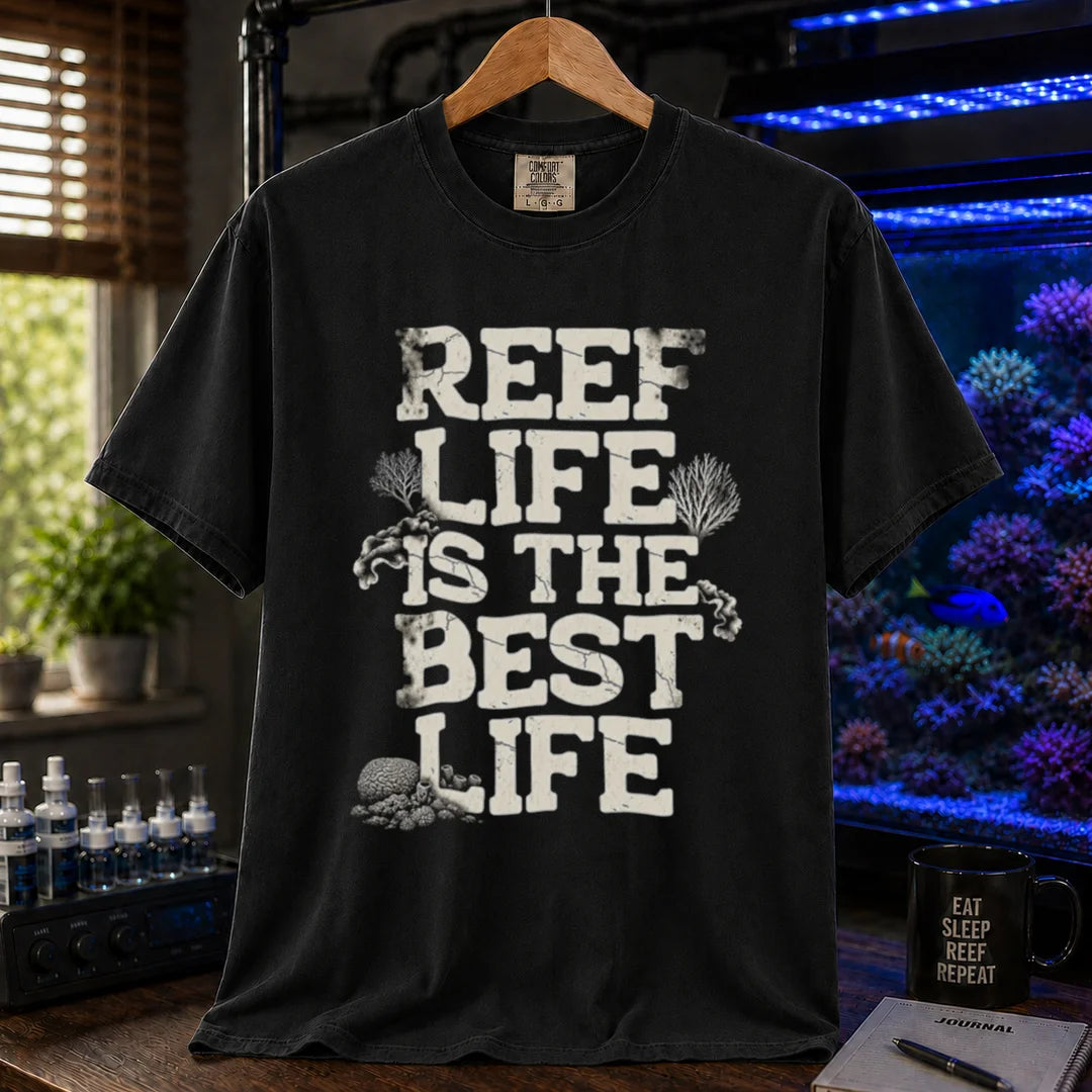 Saltwater aquarium graphic t-shirt featuring distressed white block text reading REEF LIFE IS THE BEST LIFE framed with coral illustrations, black crew neck tee