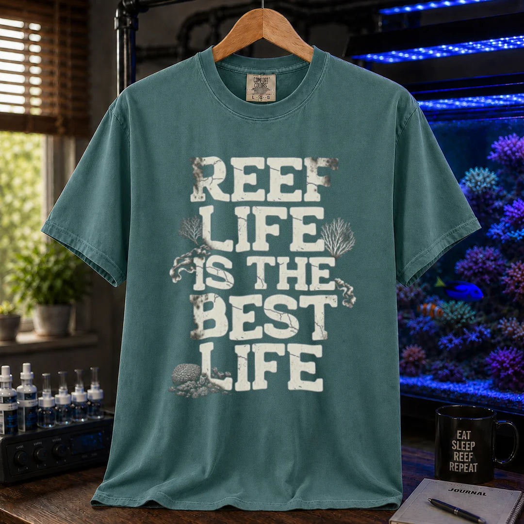 Saltwater aquarium graphic t-shirt featuring distressed white block text reading REEF LIFE IS THE BEST LIFE framed with coral illustrations, green crew neck tee