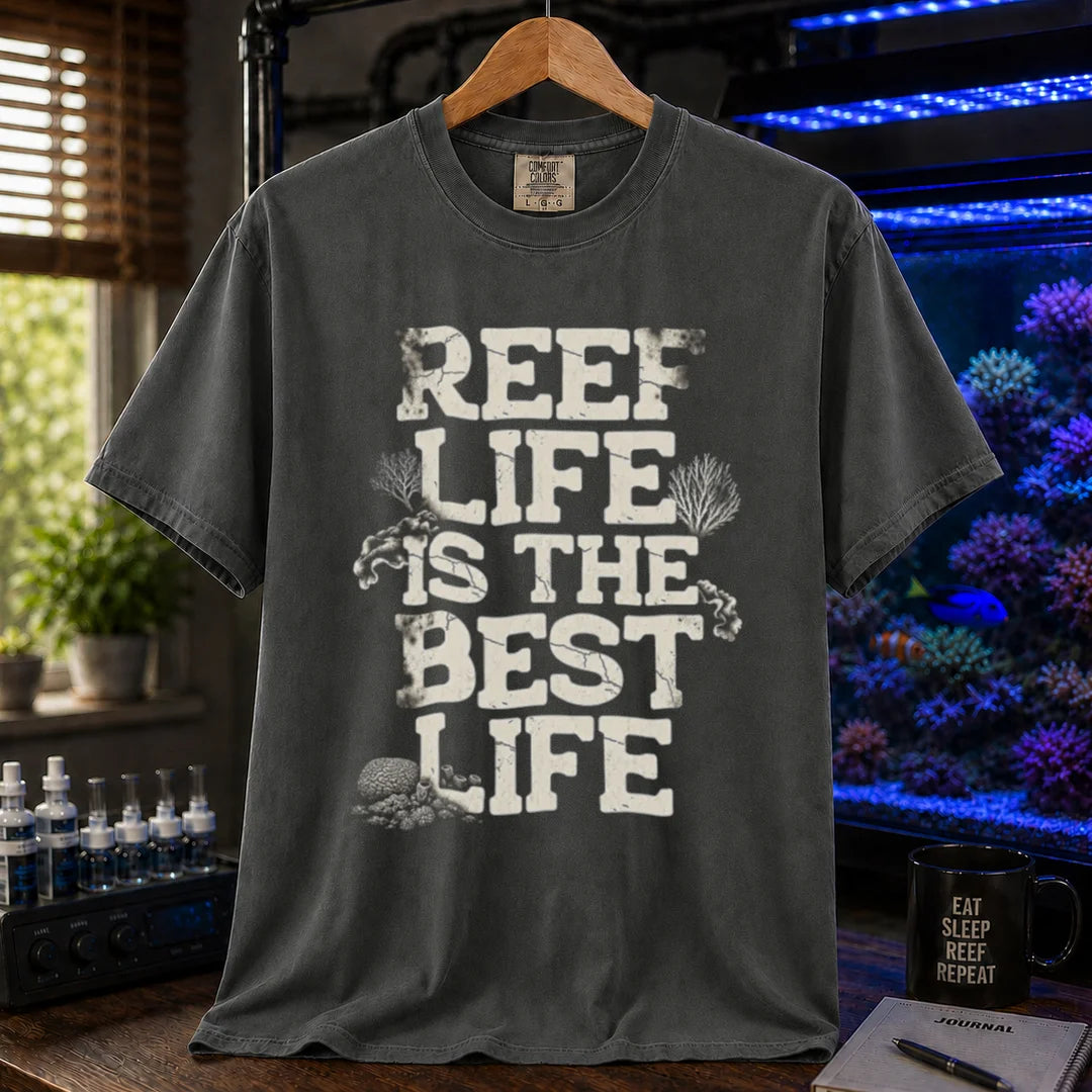 Saltwater aquarium graphic t-shirt featuring distressed white block text reading REEF LIFE IS THE BEST LIFE framed with coral illustrations, dark grey crew neck tee