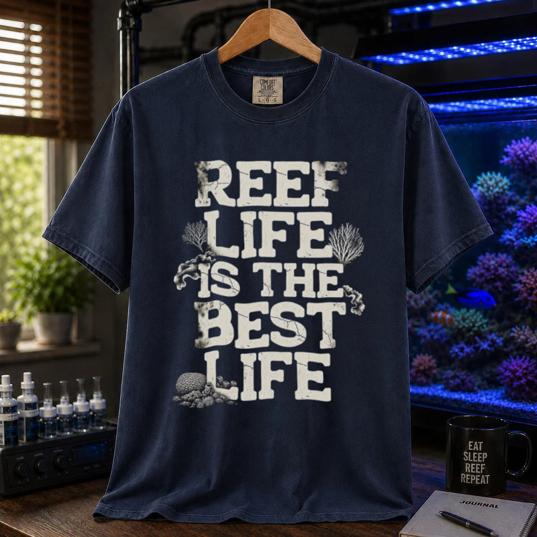 Saltwater aquarium graphic t-shirt featuring distressed white block text reading REEF LIFE IS THE BEST LIFE framed with coral illustrations, navy crew neck tee