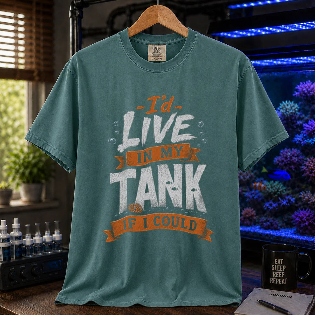 Saltwater aquarium graphic t-shirt featuring orange and white typography reading I'd Live In My Tank If I Could with bubbles and fish accents, green crew neck tee