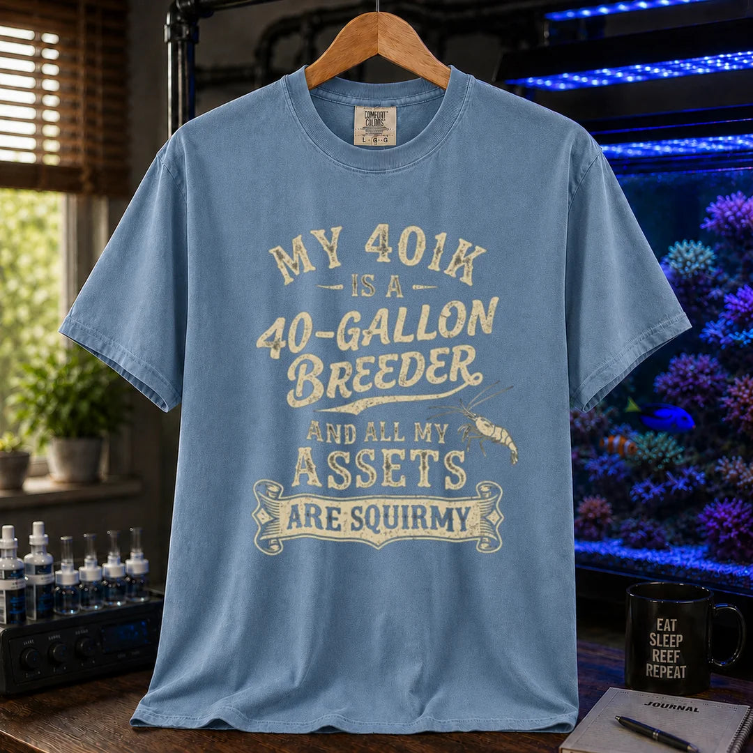Saltwater aquarium graphic t-shirt featuring cream distressed typography reading My 401k Is A 40-Gallon Breeder And All My Assets Are Squirmy with a shrimp illustration, blue crew neck tee