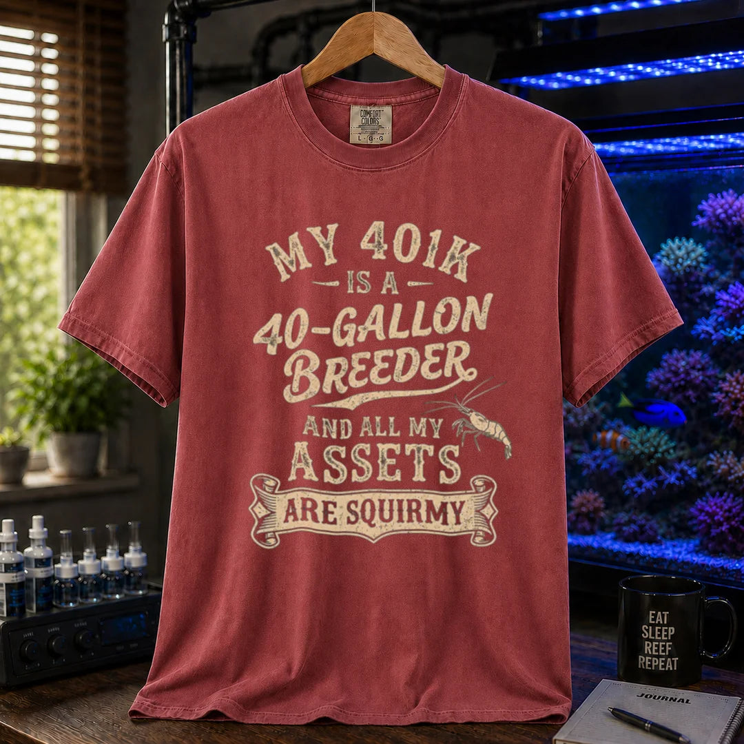 Saltwater aquarium graphic t-shirt featuring cream distressed typography reading My 401k Is A 40-Gallon Breeder And All My Assets Are Squirmy with a shrimp illustration, maroon, red crew neck tee