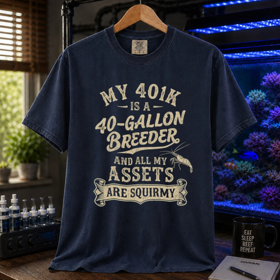 Saltwater aquarium graphic t-shirt featuring cream distressed typography reading My 401k Is A 40-Gallon Breeder And All My Assets Are Squirmy with a shrimp illustration, navy crew neck tee