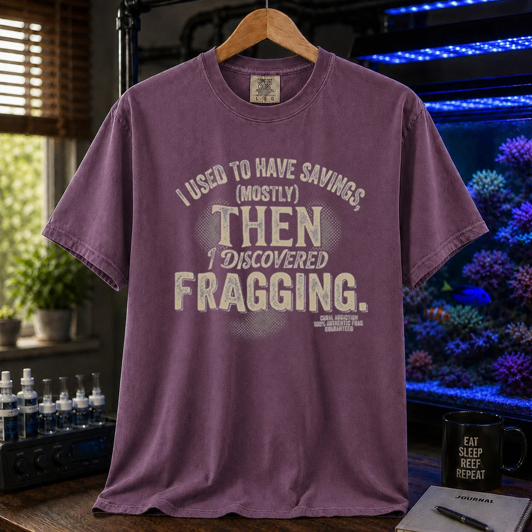 Saltwater aquarium graphic t-shirt featuring distressed cream typography reading I Used To Have Savings (Mostly) Then I Discovered Fragging with a Coral Addiction badge, purple crew neck tee