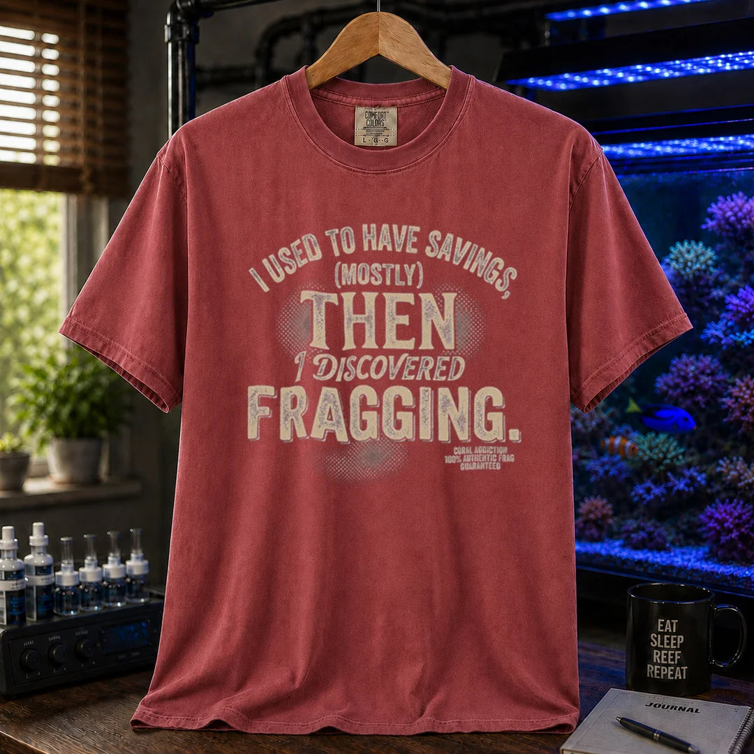 Saltwater aquarium graphic t-shirt featuring distressed cream typography reading I Used To Have Savings (Mostly) Then I Discovered Fragging with a Coral Addiction badge, maroon, red crew neck tee