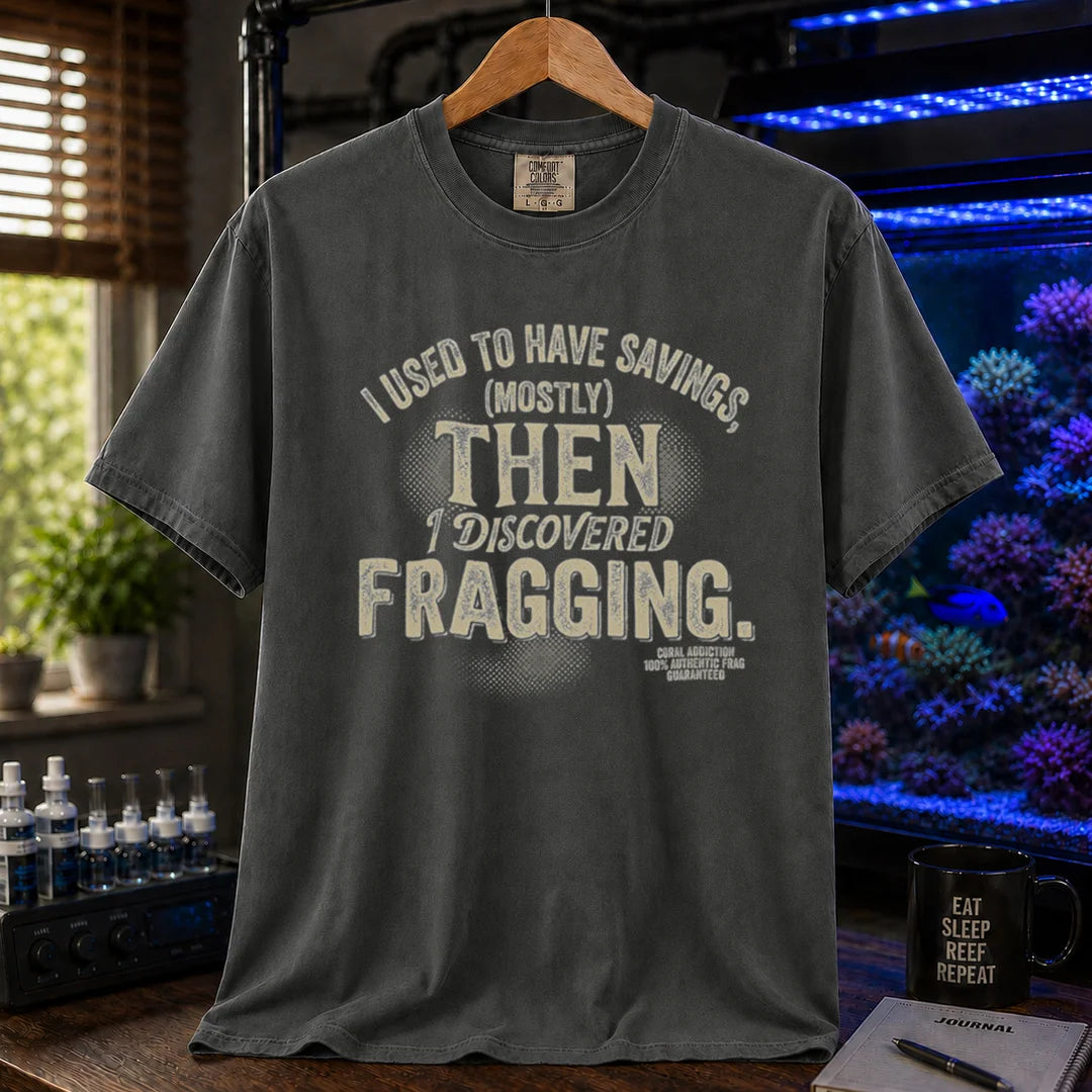 Saltwater aquarium graphic t-shirt featuring distressed cream typography reading I Used To Have Savings (Mostly) Then I Discovered Fragging with a Coral Addiction badge, dark grey crew neck tee
