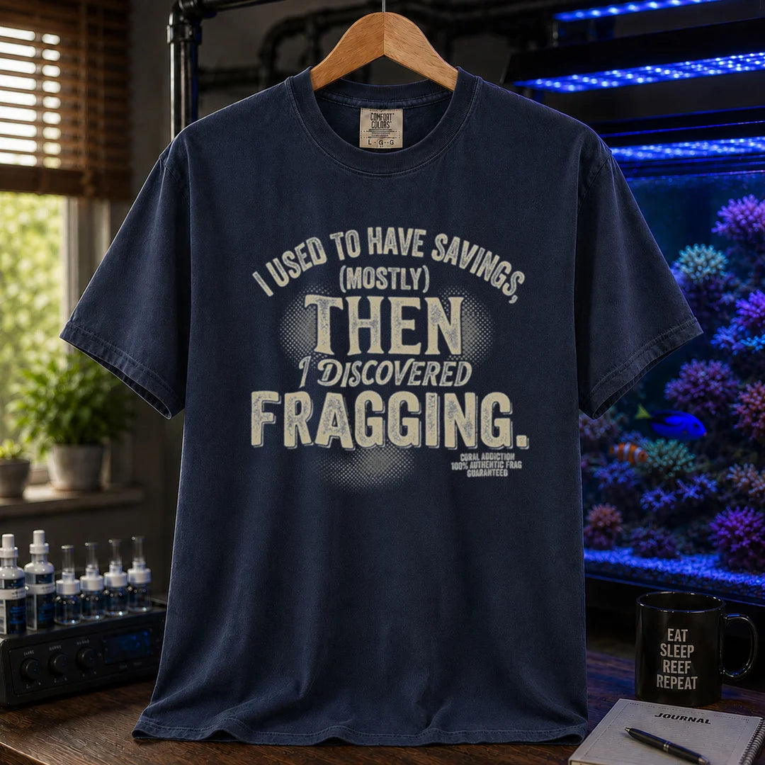 Saltwater aquarium graphic t-shirt featuring distressed cream typography reading I Used To Have Savings (Mostly) Then I Discovered Fragging with a Coral Addiction badge, navy crew neck tee