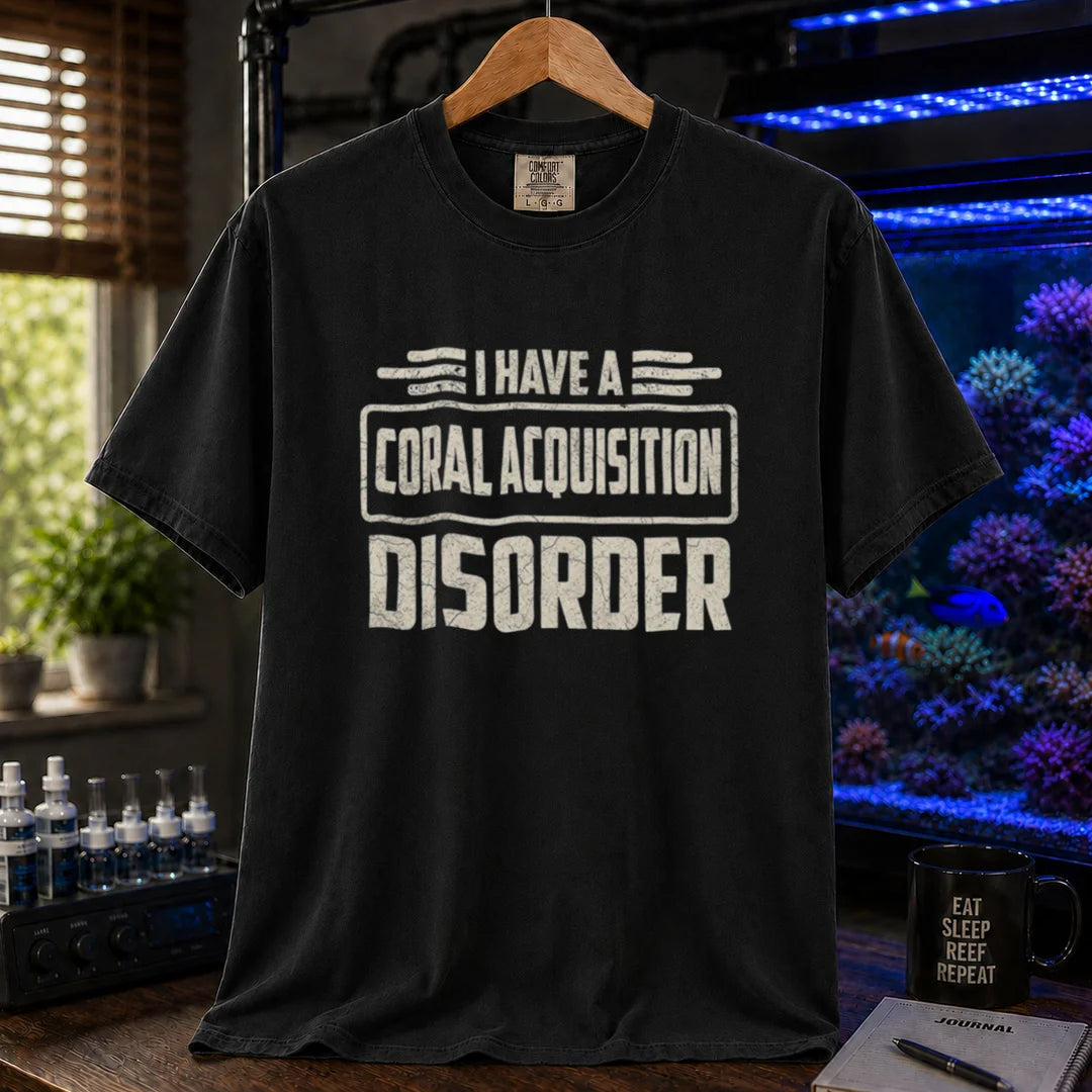 Saltwater aquarium graphic t-shirt featuring distressed cream typography reading I Have A Coral Acquisition Disorder inside a retro box frame, black crew neck tee