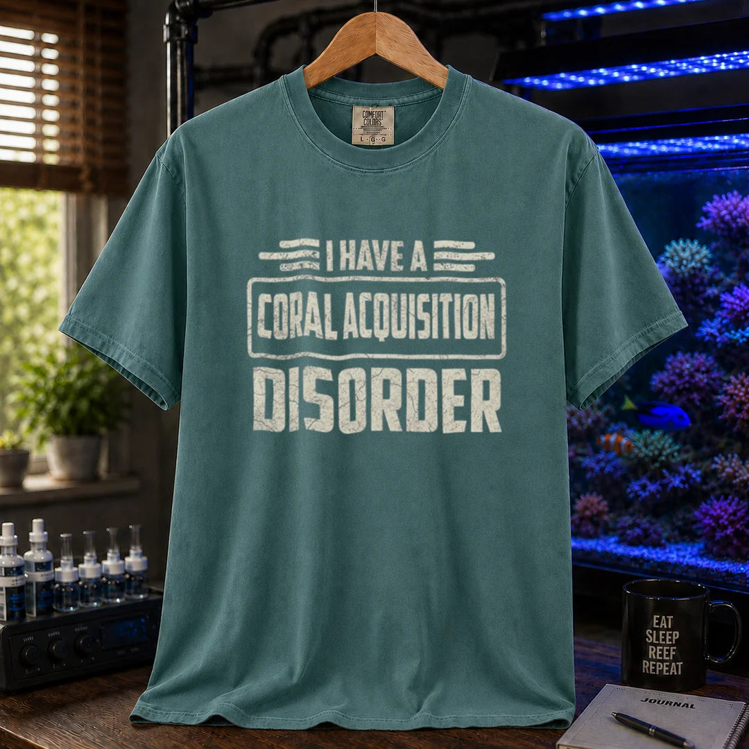 Saltwater aquarium graphic t-shirt featuring distressed cream typography reading I Have A Coral Acquisition Disorder inside a retro box frame, green crew neck tee