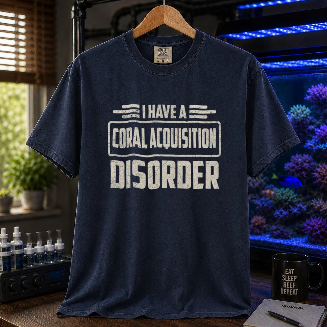 Saltwater aquarium graphic t-shirt featuring distressed cream typography reading I Have A Coral Acquisition Disorder inside a retro box frame, navy crew neck tee