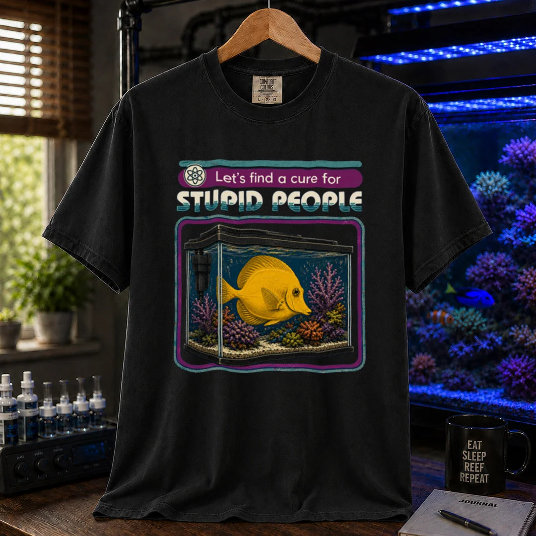 Saltwater aquarium graphic t-shirt featuring retro text reading Let's Find A Cure For Stupid People above an illustration of a yellow tang in a reef tank, black crew neck tee