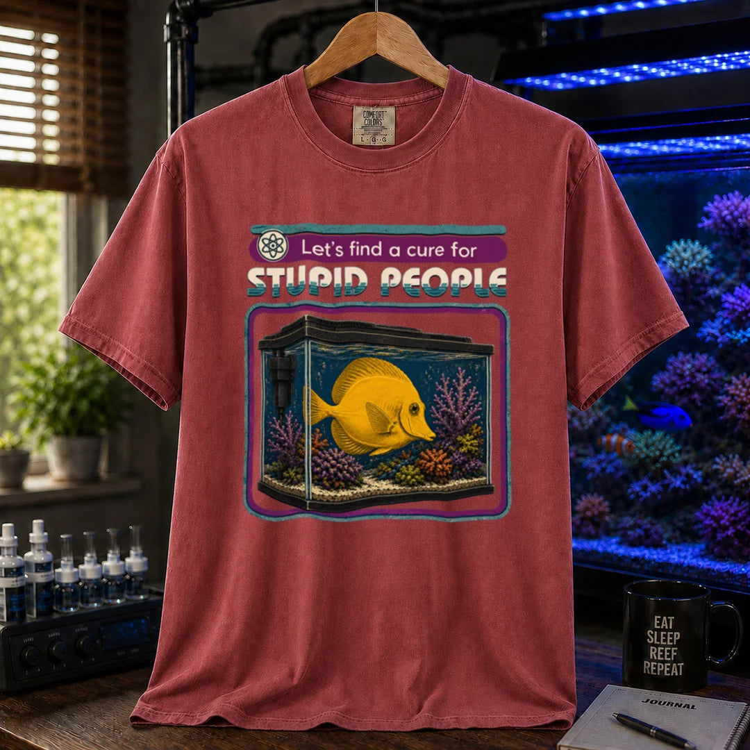 Saltwater aquarium graphic t-shirt featuring retro text reading Let's Find A Cure For Stupid People above an illustration of a yellow tang in a reef tank, maroon, red crew neck tee