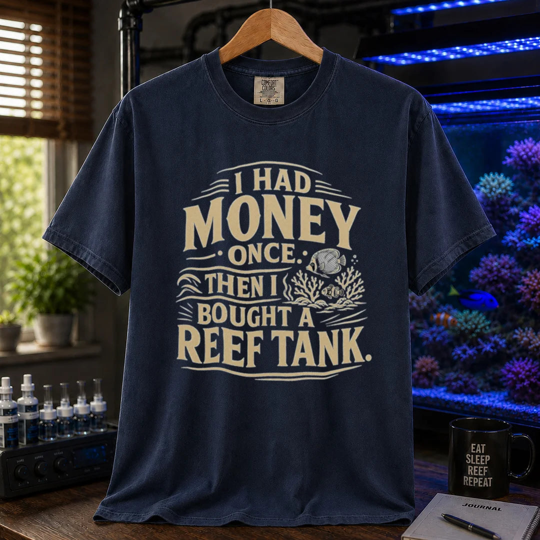 Saltwater aquarium graphic t-shirt featuring distressed cream typography reading I Had Money Once Then I Bought A Reef Tank with coral and fish illustrations, navy crew neck tee