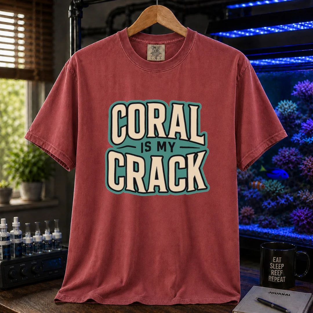 Saltwater aquarium graphic t-shirt featuring bold retro typography reading Coral Is My Crack in cream and black with a teal background accent, maroon, red crew neck tee