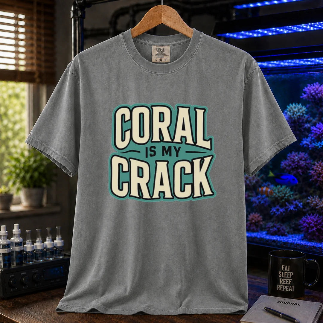 Saltwater aquarium graphic t-shirt featuring bold retro typography reading Coral Is My Crack in cream and black with a teal background accent, grey crew neck tee