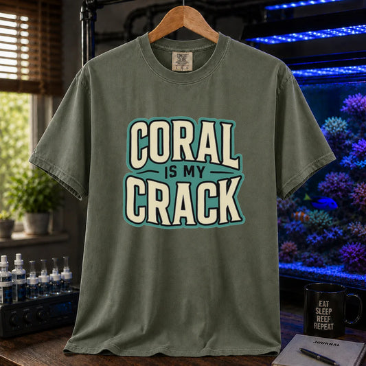 Saltwater aquarium graphic t-shirt featuring bold retro typography reading Coral Is My Crack in cream and black with a teal background accent, military green crew neck tee