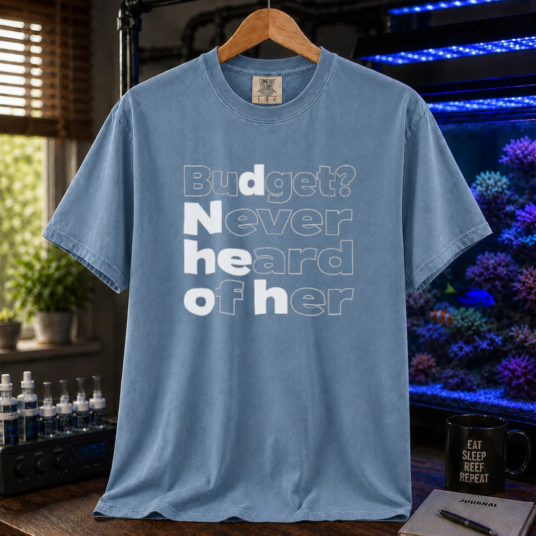 Saltwater aquarium graphic t-shirt featuring bold minimalist white typography reading Budget? Never Heard Of Her with outlined and solid letters, blue crew neck tee